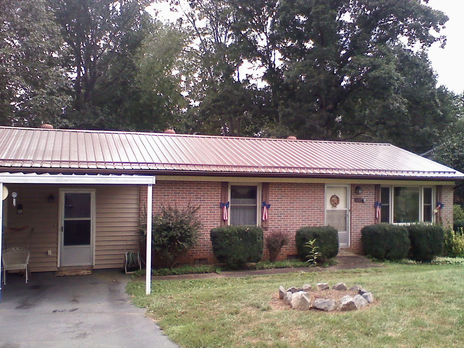 Bronze metal roof and carport on a brick ranch home — Roof Repair work by our crew in Pleasanton